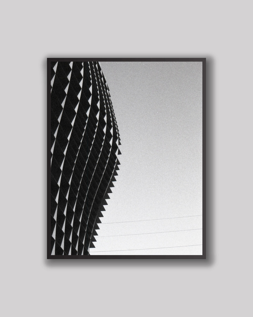 Framed black and white architectural print on a gray background