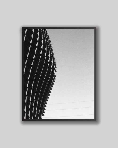 Framed black and white architectural print on a gray background