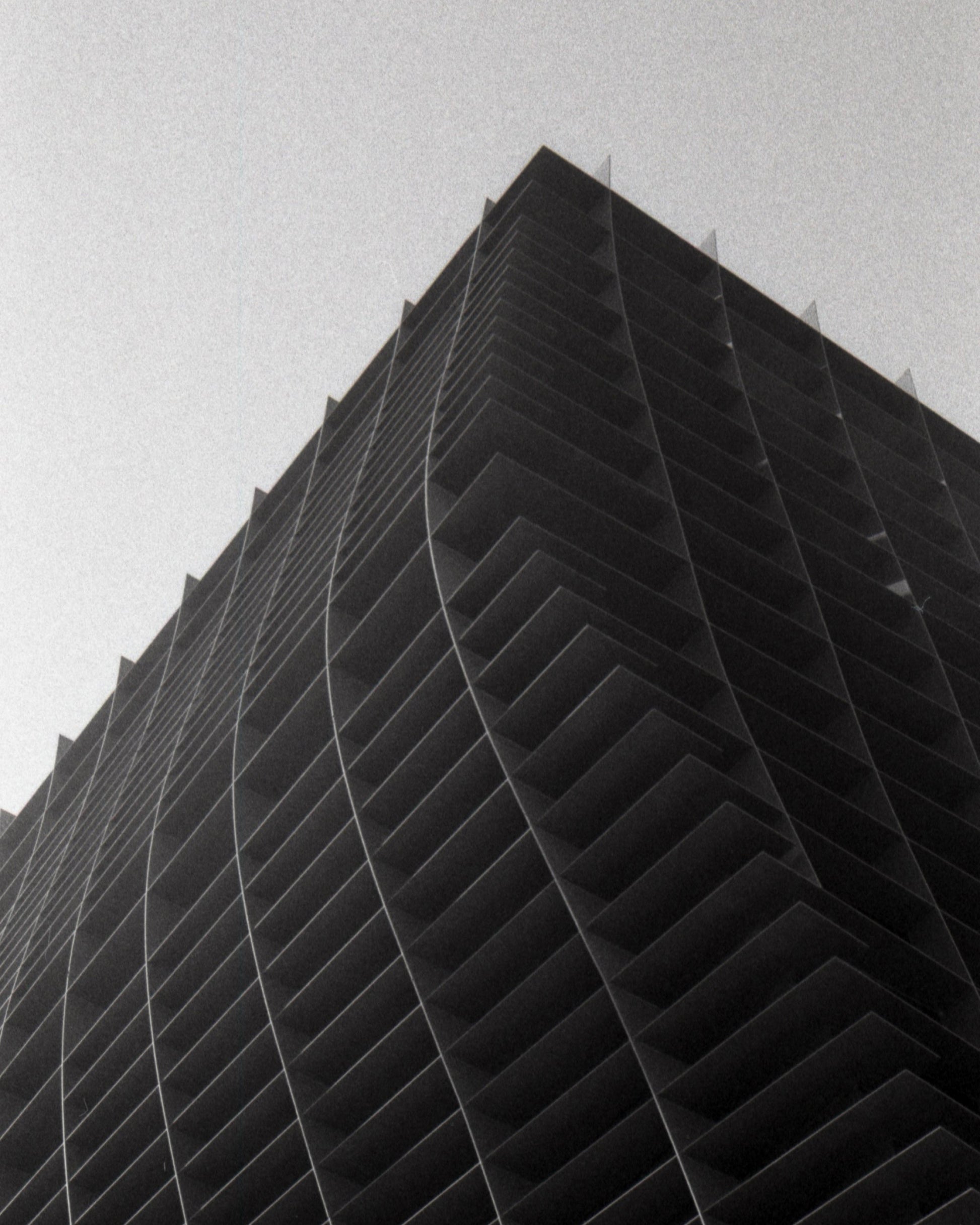 Black and white photo of a tall building with a geometric design.