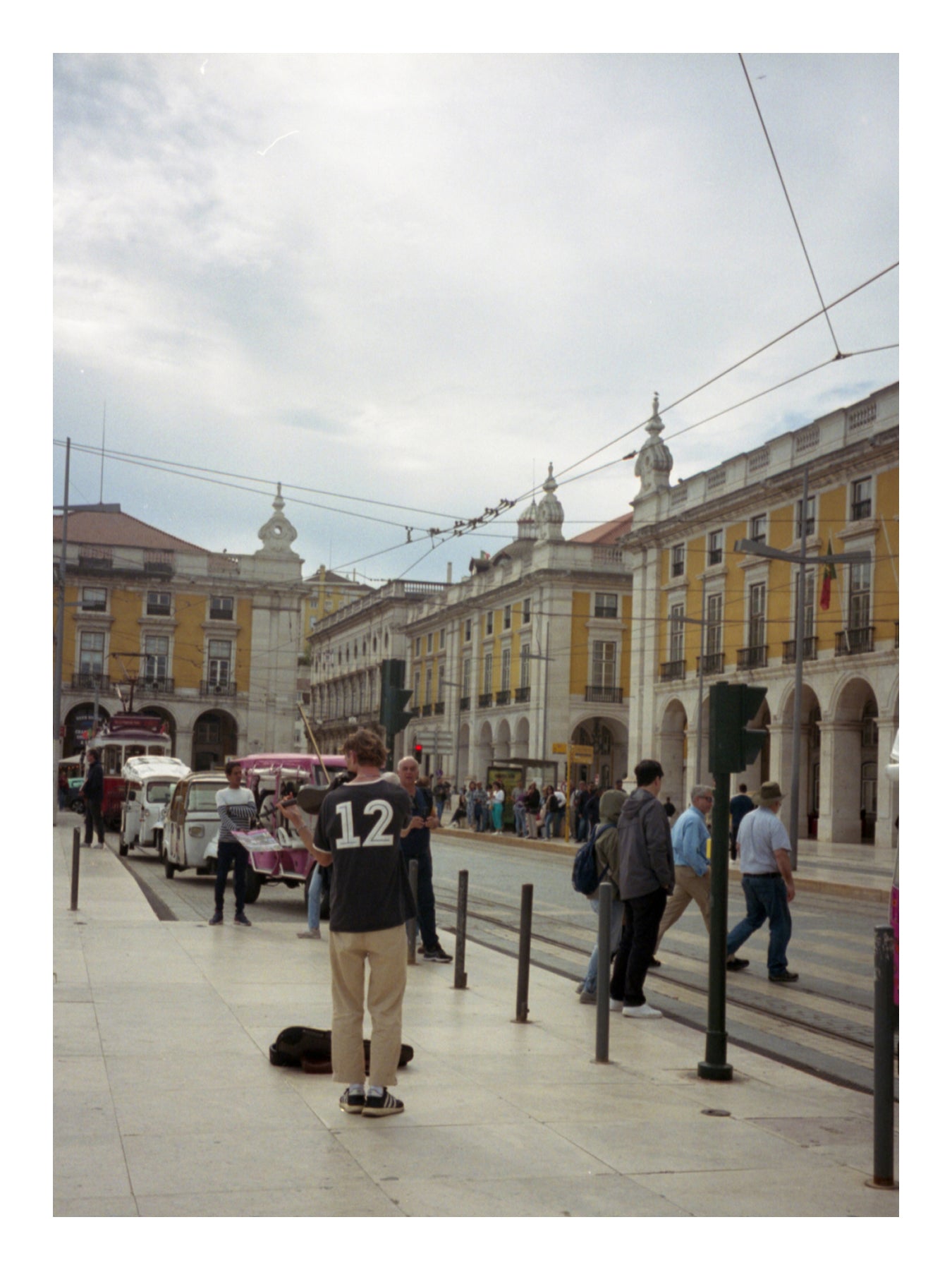 Person standing on a city street with historical buildings in the background in Lisbon Portugal